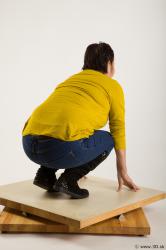 Kneeling reference of yellow sweater blue jeans Gwendolyn